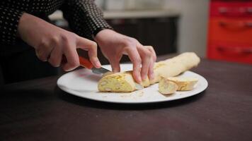 In a Home Kitchen A Hand Cuts Cantucci Biscuits Before Second Baking In Oven video