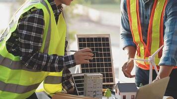 Two men in safety vests working on a solar panel video