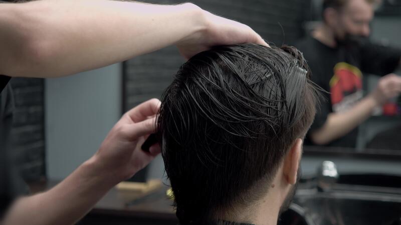 A hairdresser combs a man 39 s wet - A Hairdresser Combs A Man S Wet Black Hair In A Barbershop Before Starting A Haircut Video 