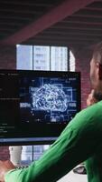 Vertical Black tech engineer programming an AI brain neural network for machine learning, doing maintenance and debugging the software systems. Technician expert uses coding language. Camera B. video