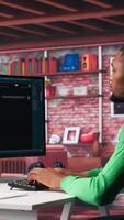Vertical African american guy at home asks questions to AI chatbot virtual assistant, typing user prompts to generate information with the artificial intelligence tool. Machine learning. Camera A. video