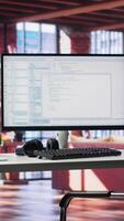 Vertical Modern loft with desktop monitor ready for coding and programming tasks, spacious workspace . Perfect environment for developing secure applications and online software systems. video
