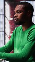 Vertical Black freelancer always eating based on stress and anxiety as bad habit, unhealthy eating disorder and nutrition. Workaholic nervous person craving snacks all the time, working at home. Camera A. video