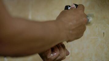 Male hands wash in a sink with foam to wash the skin and water flows through the hands. Health concept. video