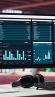Vertical Empty modern desktop ready for business development work with infographics, sleek monitor in a classy urban loft. Artistic interior design and tools for marketing and website growth. video