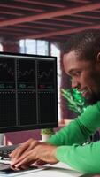 Vertical Male investor clapping hands in excitement after gaining money by selling stock and maximizing personal profit. Overjoyed guy celebrating financial gains from forex exchange trading. Camera B. video
