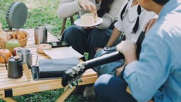 A group of people sitting around a picnic table video