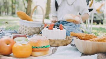 A picnic table with food and a child sitting on it video