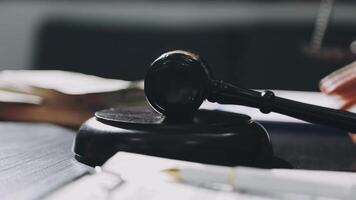 A judge's gavel on a desk with papers and a pen video