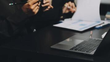 A laptop computer sitting on a table with a pen and paper video