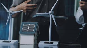 Two people standing next to a wind turbine and a house video