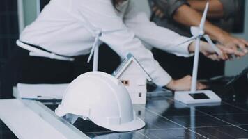 A woman in a hard hat and a man in a suit working on a solar panel video