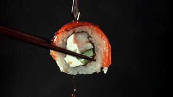 Soy sauce drips off the Japanese roll. Filmed on a high-speed camera at 1000 fps. High quality FullHD footage video