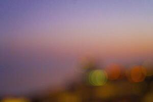 Abstract blurred background featuring soft bokeh lights in various colors, creating a dreamy atmosphere with a gradient of warm and cool tones, ideal for artistic and creative projects photo