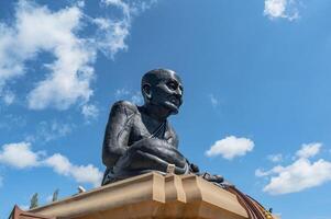 A statue of a man sitting on top of a building photo