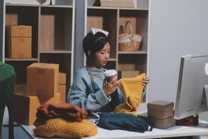 A woman is working at her desk with boxes and a cup of coffee photo