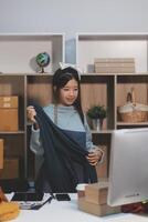 A woman is standing in front of a desk with boxes photo