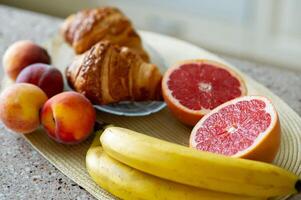 A plate of fruit and croissants photo