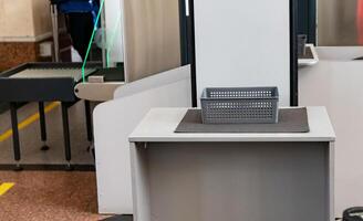 Security checkpoint with conveyor belt and inspection area in busy public space providing safety measures photo