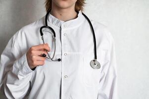 Medical professional examining stethoscope in a clinical setting during daytime photo