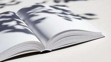 An open book with a shadow of a tree photo