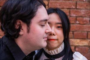 Portrait of an asian girl with half face covered by a caucasian boy, concept of integration and multi-ethnic society. photo