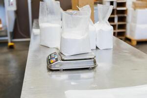 Close up of glucose in a plastic bag on a scale in a food processing facility photo