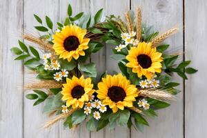 Sunflower wreath hanging on white rustic wooden planks photo