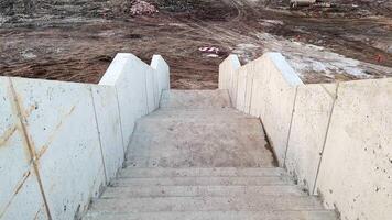 Concrete Steps Leading Down to a Construction Site for Ongoing Development and Work photo