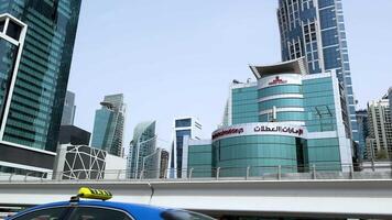 A vehicle passes by Dubai's modern skyline video