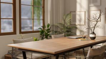 A wooden square table with decors and armchairs next to a large window with bright sunlight. photo