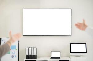A large white screen monitor on the meeting room wall. Mock up for product display or advertisement. photo