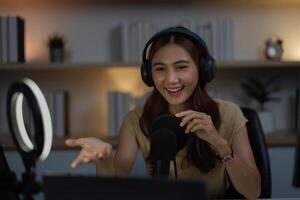 Remote Work and Digital Communication. Young woman actively participating in a call with a microphone. photo