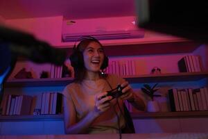 Gaming and Digital Entertainment. Young woman enjoying games in a vibrant, colorful setting. photo