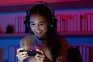 Focused Gamer Enjoying Mobile Game with Headset photo