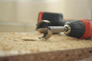 Close-up of a drill bit on a wooden surface during a project photo
