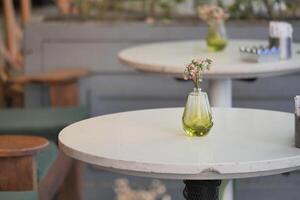 Decorative vase on a table in a cozy cafe setting photo