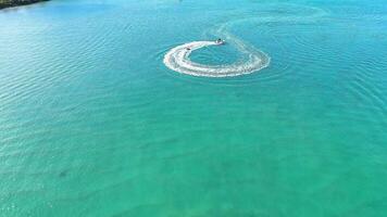 A boat creates circular patterns on water video
