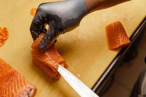 Chef arranging slices of fresh salmon photo