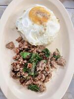 Top view of Stir fried Thai basil with minced pork and a fried egg, focus selective photo