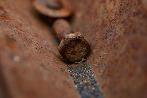 Rusty bolt and nut on old rusty metal background. Shallow depth of field. photo