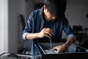 a Engineer installing Hardware man is working on a computer in a room photo