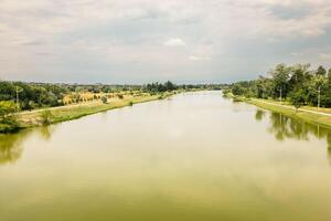 Aerial fly over view Rustavi Central Park featuring a calm lake surrounded by trees and walking paths, popular for recreation cycling and nature enjoyment in Georgia photo