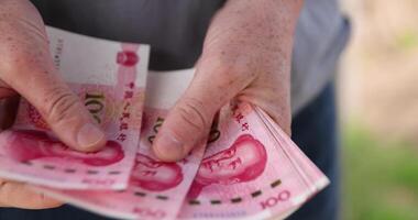 holding a large amount of money in yuan in the hands of a man photo