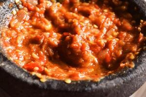 Close up of Indonesian chili tomato sambal with shrimp paste photo