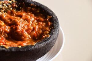 Indonesian chili tomato sambal with shrimp paste on plate photo