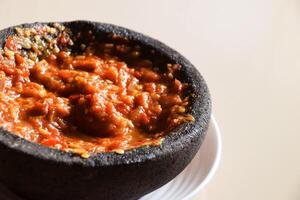 Close up of red chili tomato sambal with shrimp paste photo