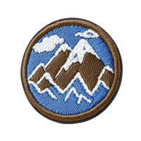 This shows round embroidered patch featuring mountain landscape with snow capped peaks and cloud against blue background. patch is bordered in brown png