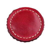 Round red leather patch with visible stitching around edges, showcasing textured surface. vibrant color and craftsmanship evoke sense of quality and style png