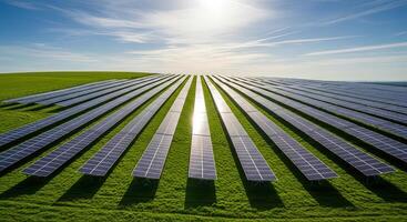 Rows of solar panels in a vast green field under a bright sun photo